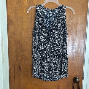 Black with White hearts. Sleeveless v neck top. Looks cute with tights